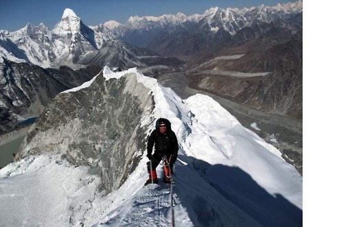 Here’s a good picture of a guy a few feet from the summit of Island Peak. The “summit ridge” runs behind him about 300 yards, and the wall is the near cliff to the left of that.