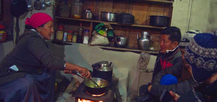 Our Sherpa host (woman on the left) preparing meals for us in Khangjim Village