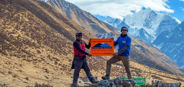 Our guide Ashish (Left) and Connors celebrate success hoisting the flag of HGT.
