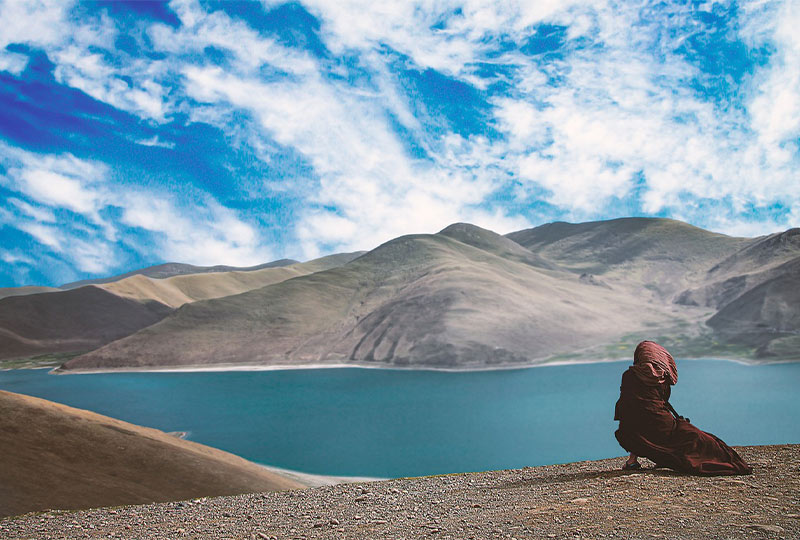 Monk at Yamdrok Taso Lake for religious ceremony