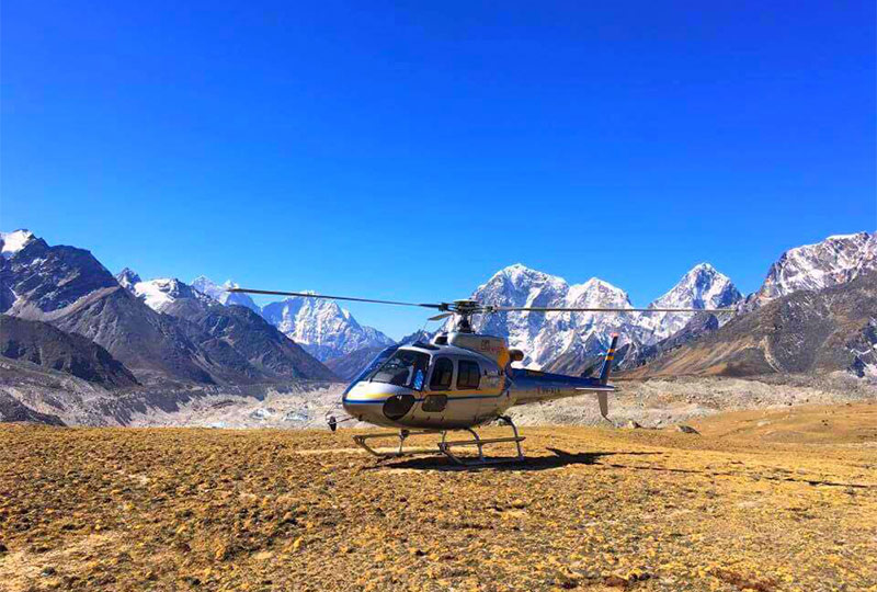 Heli parked in front of the Himalayas during the Best Time For Everest Base Camp Helicopter Tour