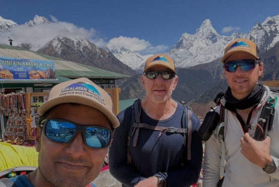 When to Book the Everest Base Camp Trek Carmen and Charlie taking selfie with guide during everest base camp trek