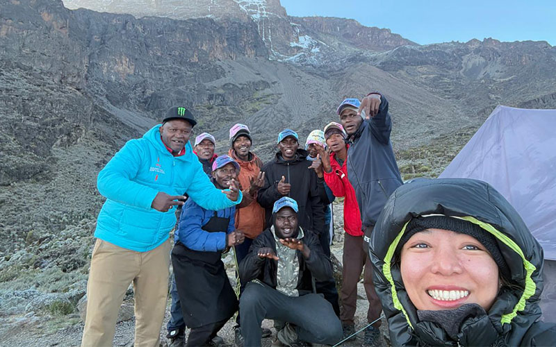 himalayan glacier guest taking selfie with team during kilimanjaro climb